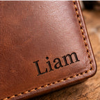 Close-up of engraved name Liam and leather stitching detail