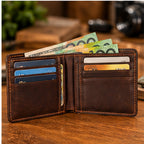 Open engraved leather wallet showing card slots and cash compartment