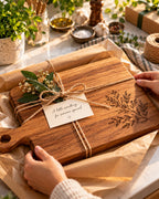 Engraved cutting board wrapped as a gift with a handwritten tag