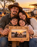 Family holding an engraved timber photo frame at an outback campsite