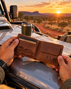 Engraved leather wallet on the bonnet of a 4WD in the outback